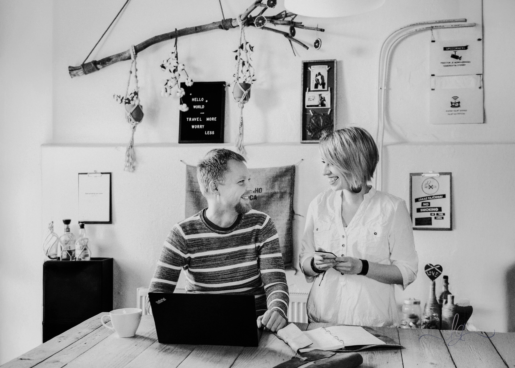 A man and a woman in a casual, creative work environment in a studio.